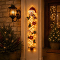 Playful clown Christmas door hanger in a Santa hat with trees, stars and ornaments