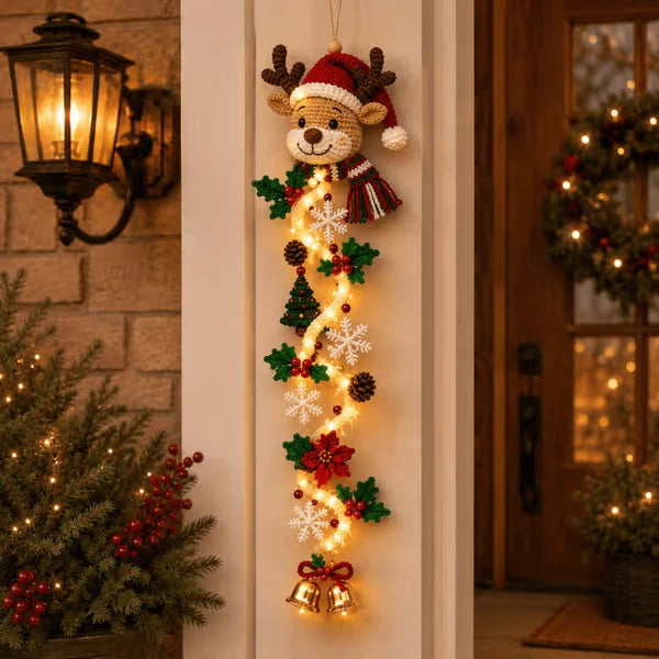 Smiling reindeer Christmas door hanger in a Santa hat with stars and ornaments